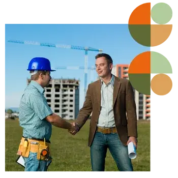 Developer in a blazer shaking hands with a construction worker on site with cranes and buildings in the background, symbolising trust and collaboration. Represents Air Theory’s commercial mechanical systems for developers and asset owners—performance-led, approval-ready, on-budget.