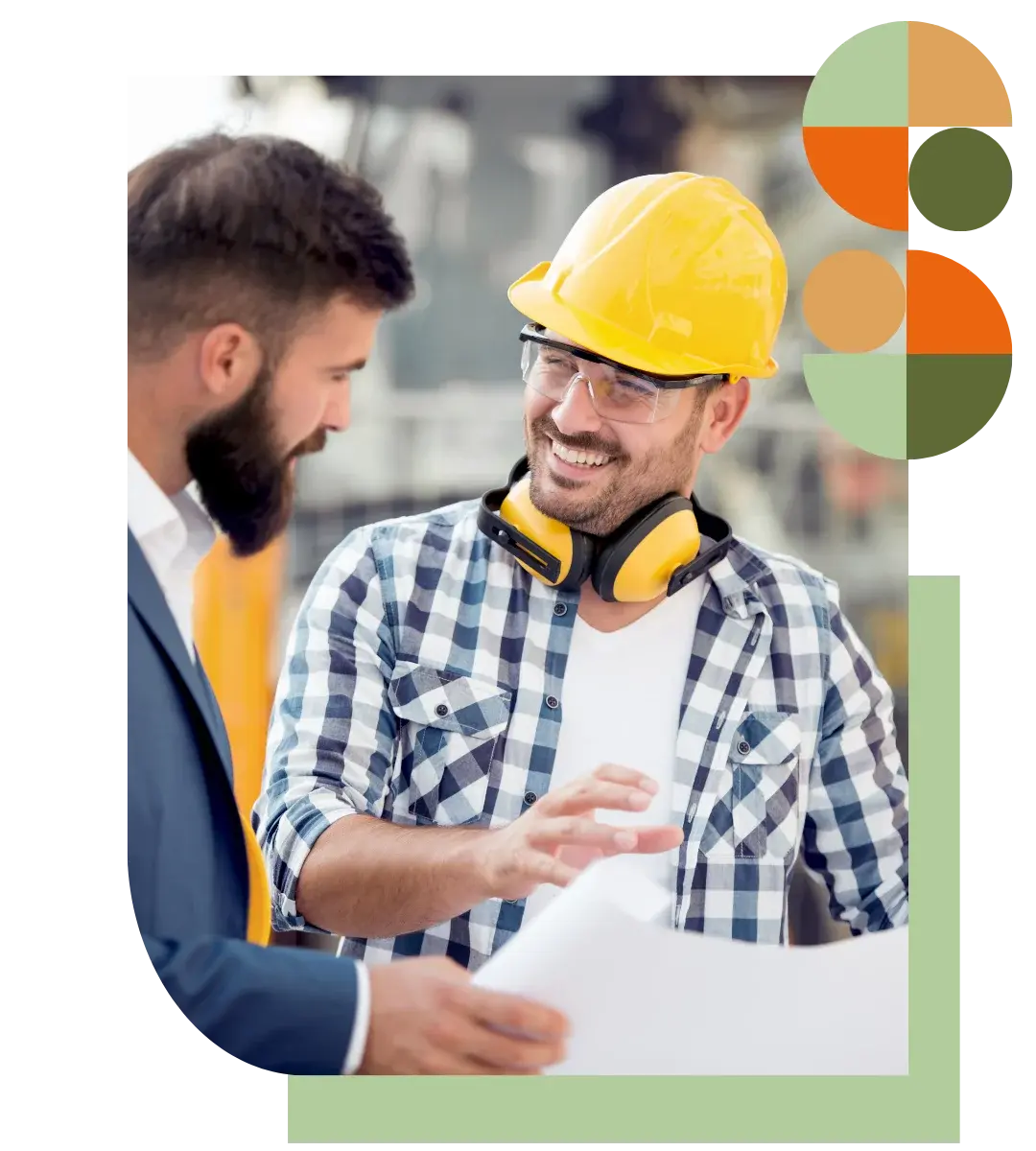 An Air Theory HVAC consultant in a yellow hard hat reviews building plans with an architect on-site, showcasing collaborative project support and expert mechanical input at any stage of construction.