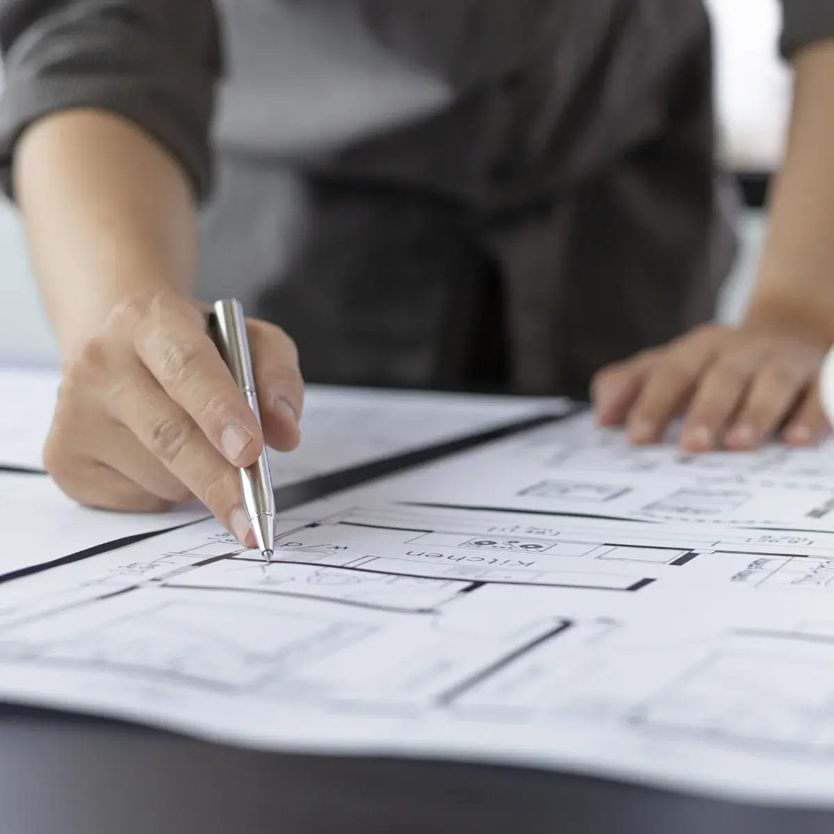 Architect reviewing mechanical and HVAC drawings — a key moment in Air Theory’s consult phase, ensuring system performance, compliance, and buildability are designed in from the start.